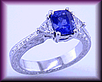 Sapphire and trilliant diamond platinum hand engraved ring.
