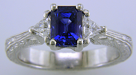 Sapphire ring with trilliant diamond and hand engraved platinum.