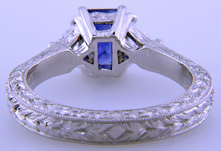 Inside view of platinum hand-engraved ring with emerald-cut sapphire and diamonds.