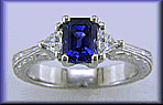 Sapphire and trilliant diamond platinum hand engraved engagement rings.