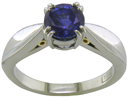 Platinum sapphire ring with two hidden diamonds and 18kt gold accents. (J5348)