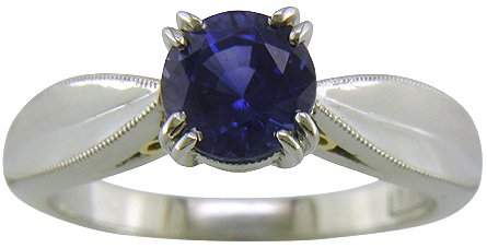 Platinum sapphire ring with two hidden diamonds and 18kt gold accents. (J5348)