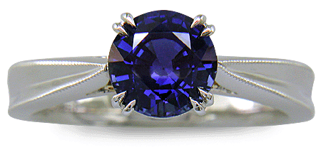 Sapphire ring handcrafted in platinum with two hidden diamonds and gold accents. (J8751)
