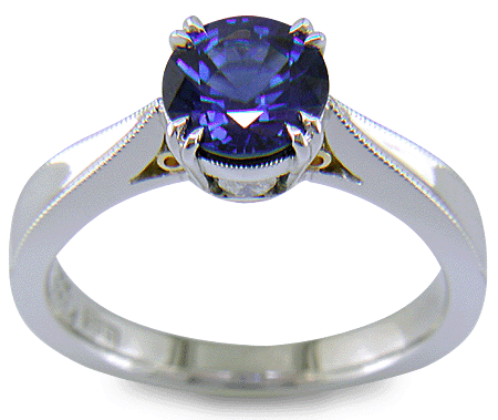 Sapphire ring handcrafted in platinum with two hidden diamonds and gold accents. (J8751)