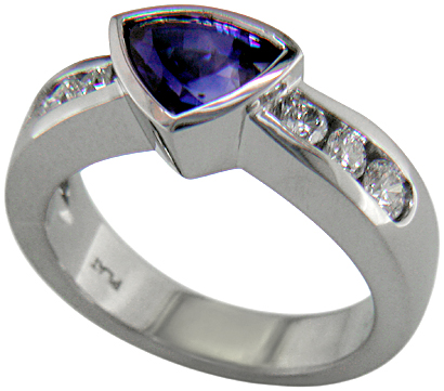 Channel set diamonds in trillium sapphire platinum ring. (J6413)