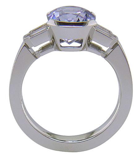 Side view of handcrafted platinum ring with a steely blue Sapphire and sparkling baguette diamonds. (J8516)