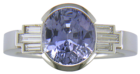 A handcrafted platinum ring with a steely blue Sapphire and sparkling baguette diamonds. (J8516)