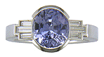 A handcrafted platinum ring with a steely blue Sapphire and sparkling baguette diamonds.