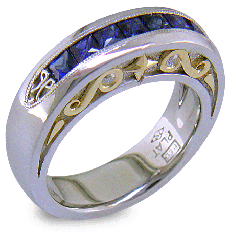 Seven Princess-cut Sapphires set in a platinum ring with diamonds and 18kt gold accents. (J7420)