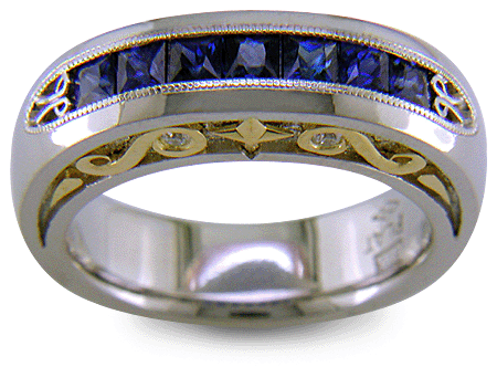 Seven Princess-cut Sapphires set in a platinum ring with diamonds and 18kt gold accents. (J7420)