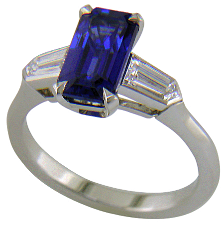 A handcrafted platinum ring with a sriking emerald-cut Sapphire and sparkling bullet-shape diamonds.