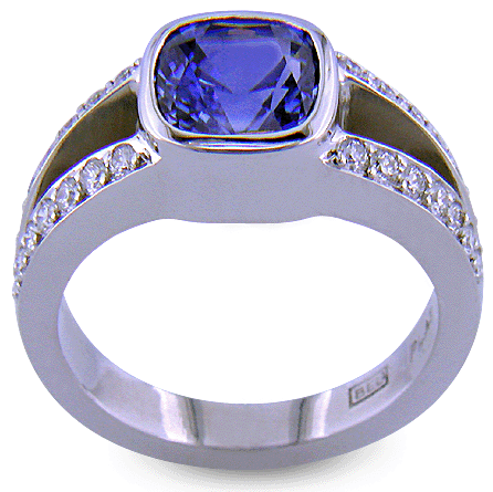 Side view of a cushion-cut sapphire set with diamonds in a custom platinum ring.