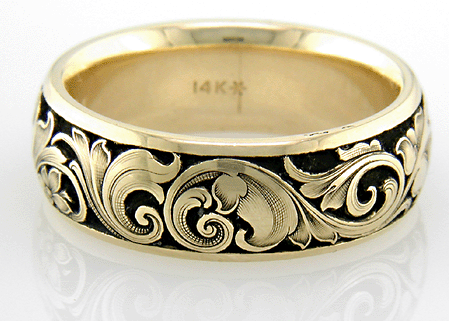 14kt godl band with floral relief engraving on a black background.