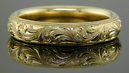 18kt gold band with hand engraved scrolls.
