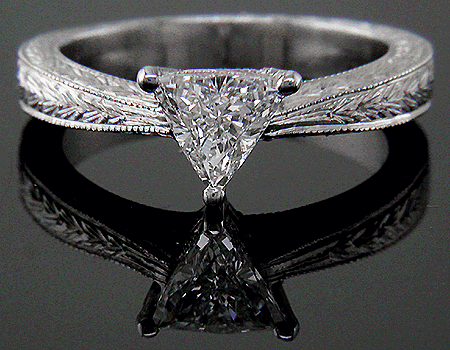 Trilliant diamond platinum hand engraved ring.