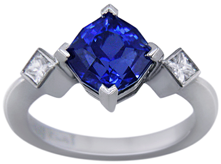 Starburst-cut sapphire set with two brilliant diamonds in a custom platinum ring.