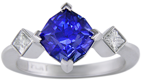 Starburst-cut sapphire set with two brilliant diamonds in a custom platinum ring.