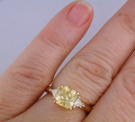 square-radiant-cut Yellow Sapphire set with two brilliant-cut diamonds in a handcrafted 18kt gold and platinum ring. (J8711)