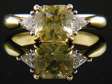 square-radiant-cut Yellow Sapphire set with two brilliant-cut diamonds in a handcrafted 18kt gold and platinum ring. (J8711)