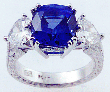 Engraved platinum ring with tanzanite and heart-shape diamonds.