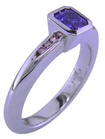 Shoulder view of custom platinum tanzanite and pink diamonds ring.