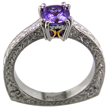 A tanzanite solitaire in a hand engraved platinum ring.