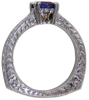 Hand engraved platinum ring with a tanzanite solitaire.