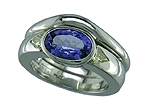 Platinum engagement rings featuring an oval tanzanite and trilliant fancy yellow diamonds with matching wedding band.