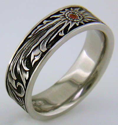 Hand engraved wedding band with Mandarin garnet.