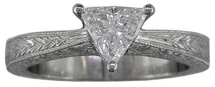 Trilliant diamond platinum hand engraved ring.