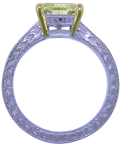 Side view of trilliant yellow diamond set in a hand-engraved platinum ring. (J5245)