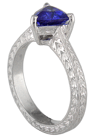 Sapphire and engraved platinum engagement ring.