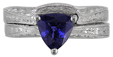 Platinum and sapphire engraved ring with matching band.