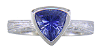 Concaved-facetted trillium Sapphire set in a handcrafted, hand-engraved platinum ring. (J8707)