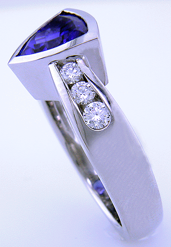 Channel set diamonds in trillium tanzanite platinum ring.