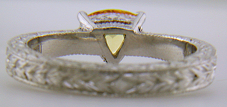 Inside of hand-engraved ring with trillium yellow sapphire.