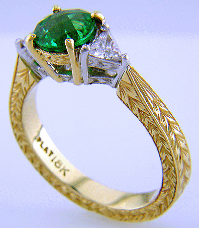 Side view of 18kt gold ring with tsavorite garnet and diamonds set in platinum.