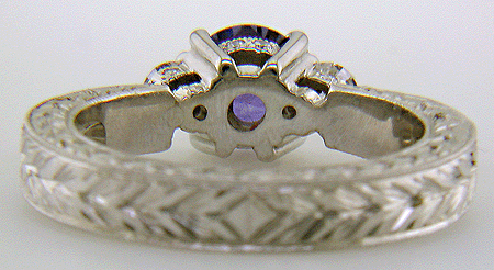 Inside of platinum hand-engraved ring with violet sapphire and diamonds.