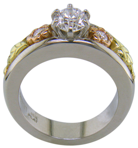 Custom platinum engagement ring with rose and green gold accents.