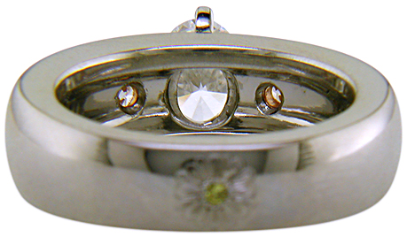 Inside view of custom platinum engagement ring with rose and green gold accents.
