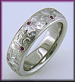 Hand engraved flower platinum band set with Pink Sapphires.