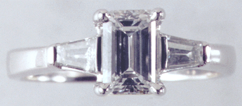 Platinum engagement ring with emerald cut diamond.