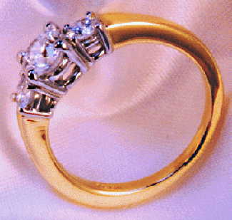 3/4 view of ideal cut diamond engagement ring in platinum and yellow gold.