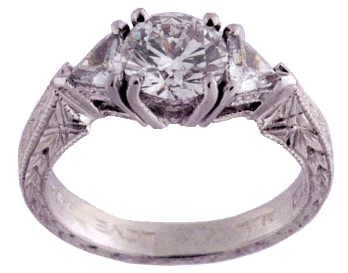 Hand engraved platinum ring with diamonds.