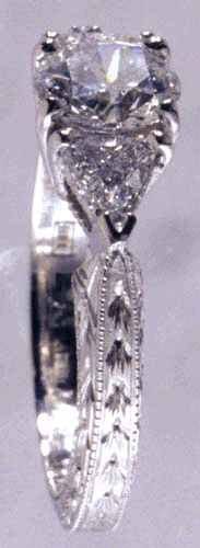 Side-view of engraved platinum ring with diamonds.