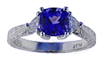 Engraved platinum ring with tanzanite and trilliant diamonds.