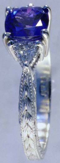 Side view of the engraved platinum ring with tanzanite and diamonds.