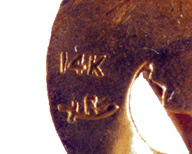 Close-up of griffin pins hallmark and gold stamp. (J3578)