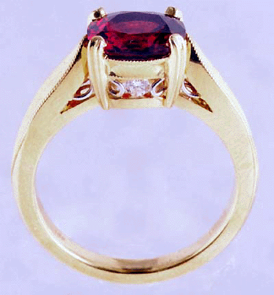 Side view of red spinel ring with diamonds and platinum accents .