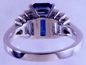 Inside view of platinum ring with an emerald-cut sapphire and baguette diamonds. (J3868)